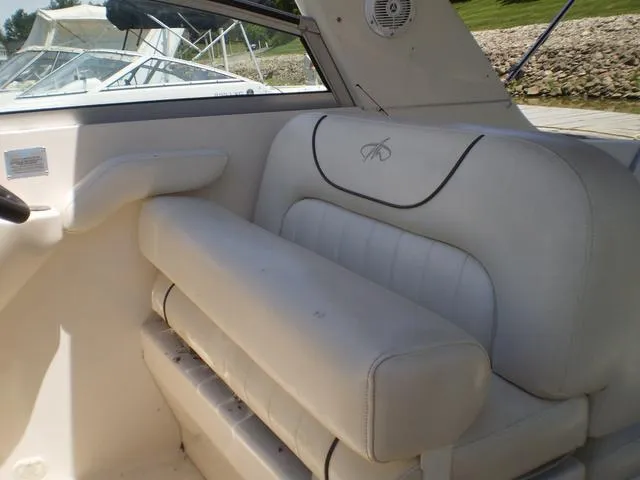 Slide: The Image of 2003 Monterey 302 boat interior with white leather seating and window view. - 13