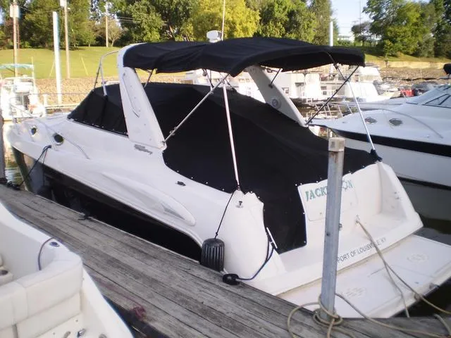 Slide: The Image of 2003 Monterey 302 boat docked with black canopy and cover. - 5