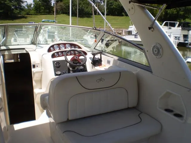Slide: The Image of 2003 Monterey 302 boat interior with helm and seating area. - 9