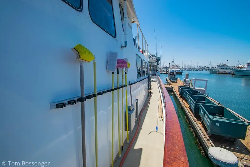 Slide: The Image of 1975 Blanchard Passenger Sportfisher docked at marina, cleaning tools visible on deck. - 17