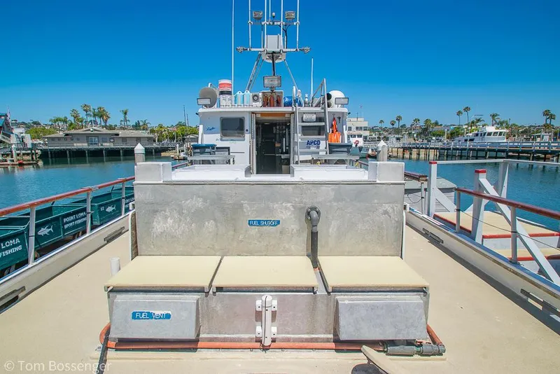 Slide: The Image of 1975 Blanchard Passenger Sportfisher boat docked in sunny marina, featuring spacious deck and equipment. - 24