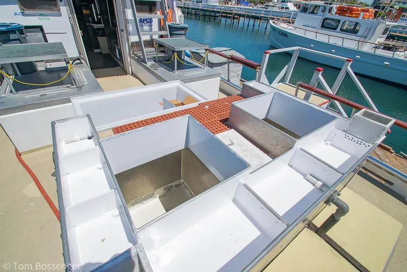 Slide: The Image of 1975 Blanchard Passenger Sportfisher deck with storage compartments, docked at marina. - 28