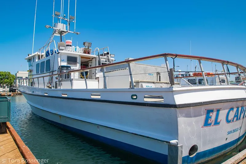 Slide: The Image of 1975 Blanchard Passenger Sportfisher boat docked in a marina under clear blue sky. - 3