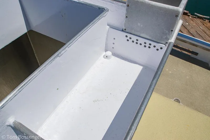 Slide: The Image of 1975 Blanchard Passenger Sportfisher boat interior detail with white compartment and metal edges. - 32