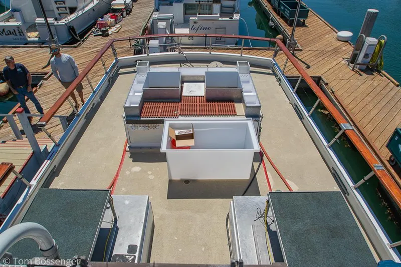 Slide: The Image of 1975 Blanchard Passenger Sportfisher deck with seating and storage, docked at marina. - 36