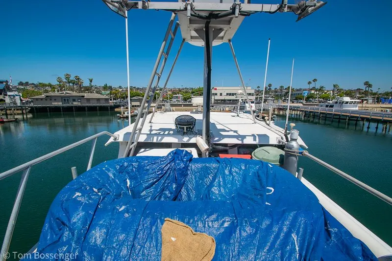 Slide: The Image of 1975 Blanchard Passenger Sportfisher boat docked, covered with blue tarp, sunny day. - 38
