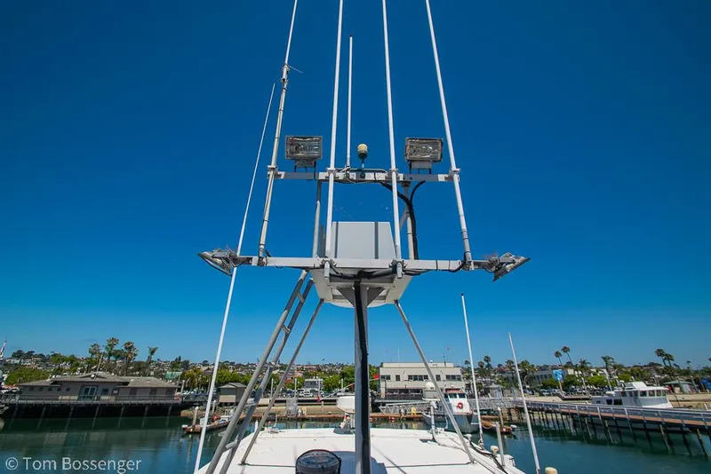 Slide: The Image of 1975 Blanchard Passenger Sportfisher boat with antennas, docked in a marina under clear blue sky. - 39