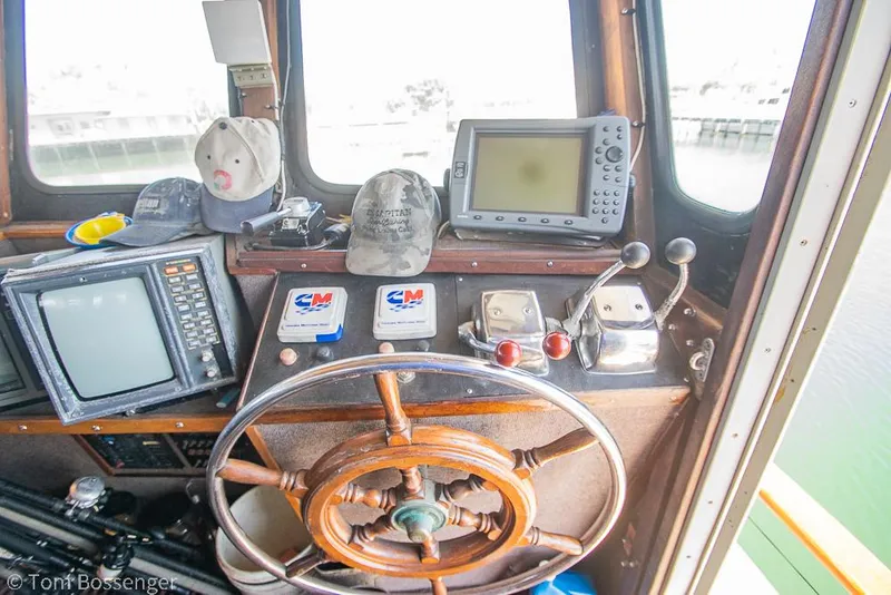Slide: The Image of 1975 Blanchard Passenger Sportfisher helm with vintage navigation equipment and steering wheel. - 4