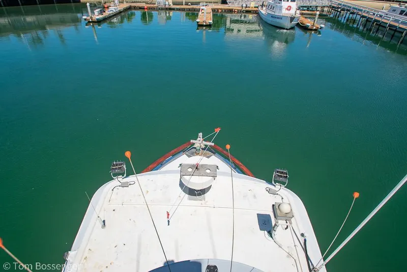 Slide: The Image of Bow view of 1975 Blanchard Passenger Sportfisher in a marina setting. - 42