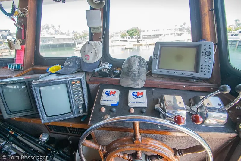 Slide: The Image of 1975 Blanchard Passenger Sportfisher helm with navigation equipment, steering wheel, and control panels. - 8