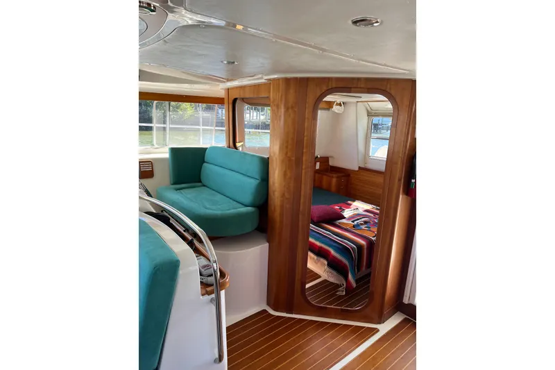 Slide: The Image of Interior of 2008 PDQ MV-41 boat with teal seating and cozy cabin. - 12