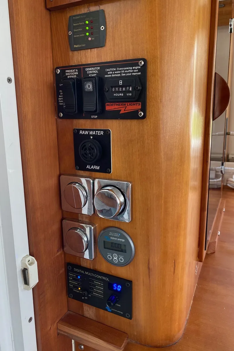 Slide: The Image of 2008 PDQ MV-41 interior with wood cabinetry, TV, and control panel. - 16