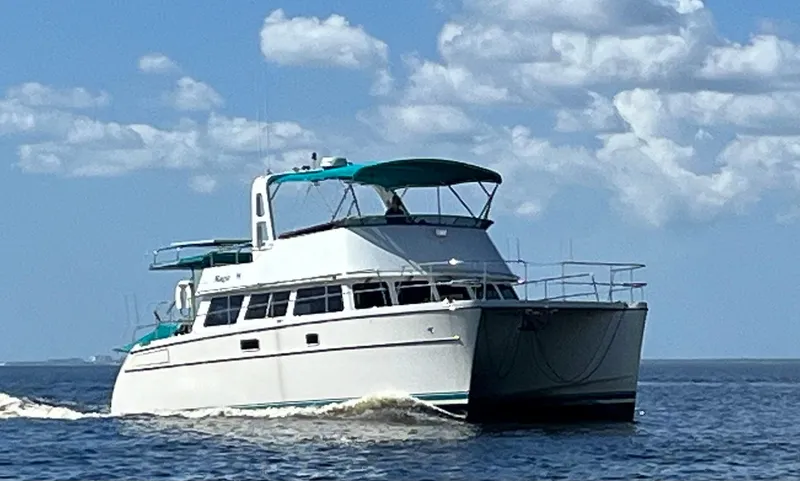 Slide: The Image of 2008 PDQ MV-41 yacht cruising on open water under a clear blue sky. - 2
