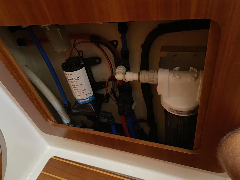 Slide: The Image of Wooden cabinet with open door, displaying stacked white dishes and bowls. PDQ MV-41, 2008 model. - 27