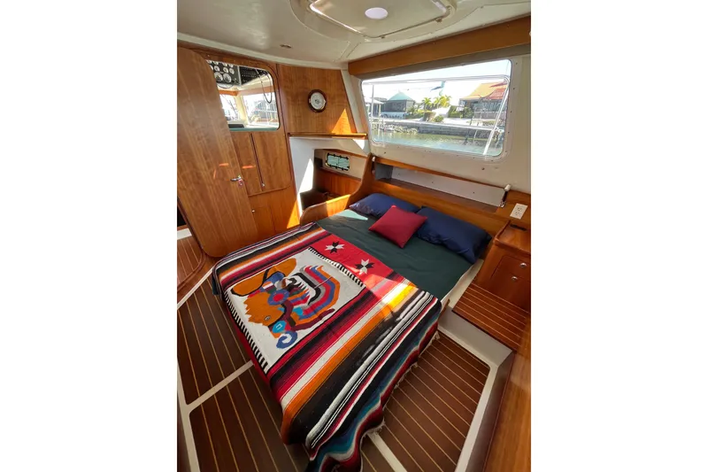 Slide: The Image of Interior of 2008 PDQ MV-41 boat with wooden paneling and cozy seating area. - 30