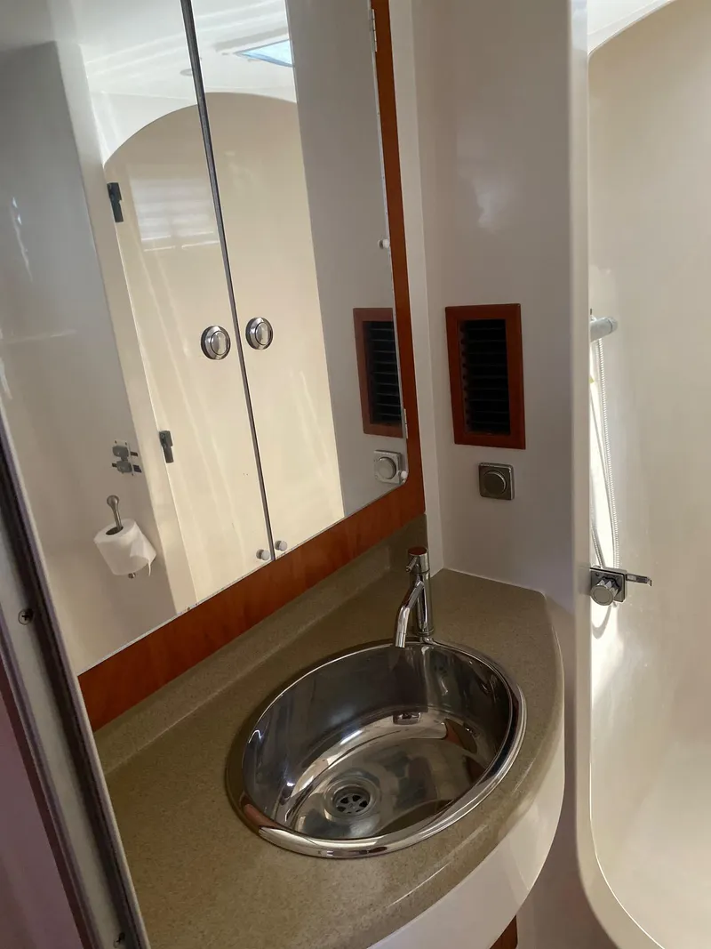 Slide: The Image of Wooden cabinetry with open drawers in a 2008 PDQ MV-41 boat interior. - 37