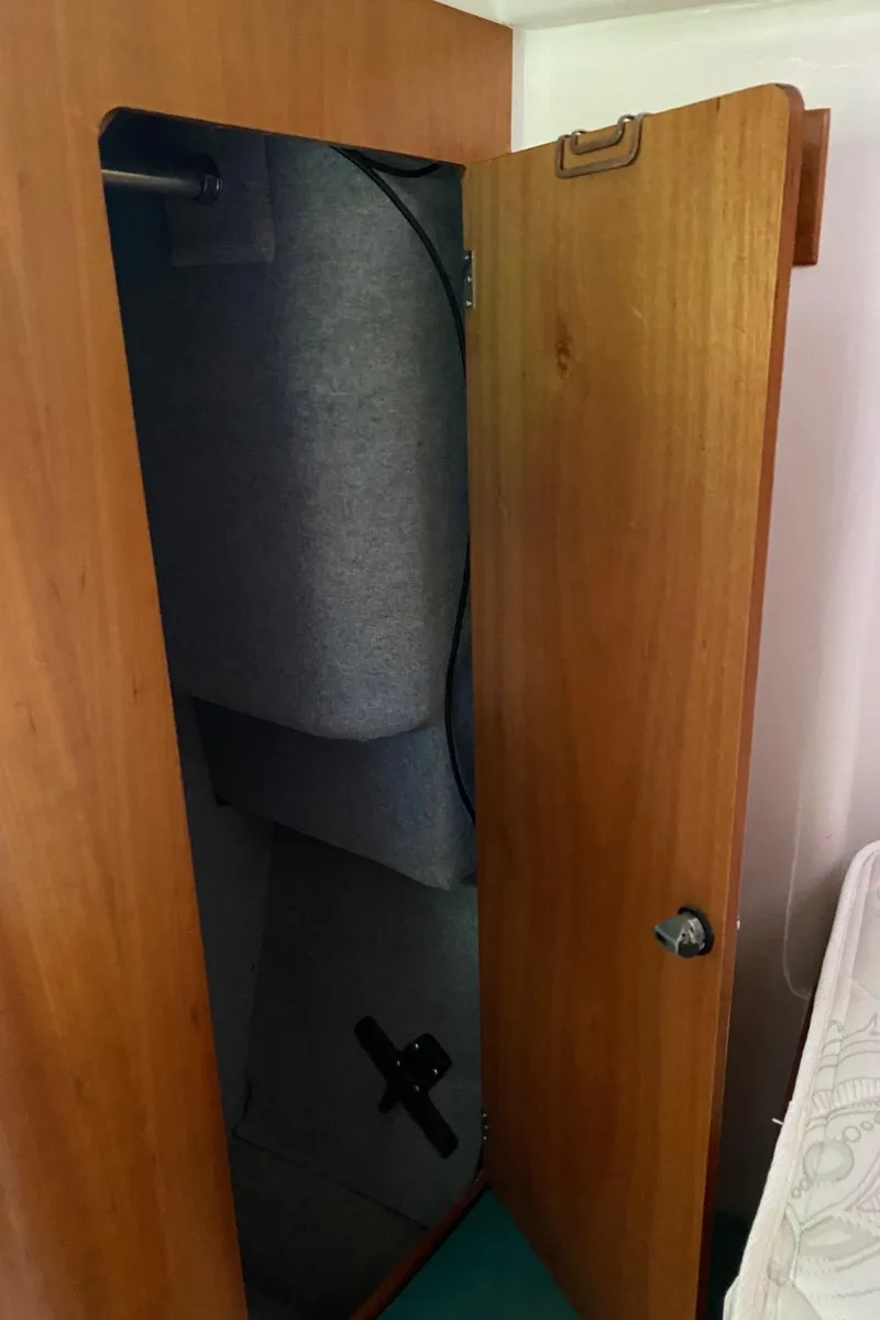 Slide: The Image of Wooden interior of a 2008 PDQ MV-41 boat with open storage compartment. - 42