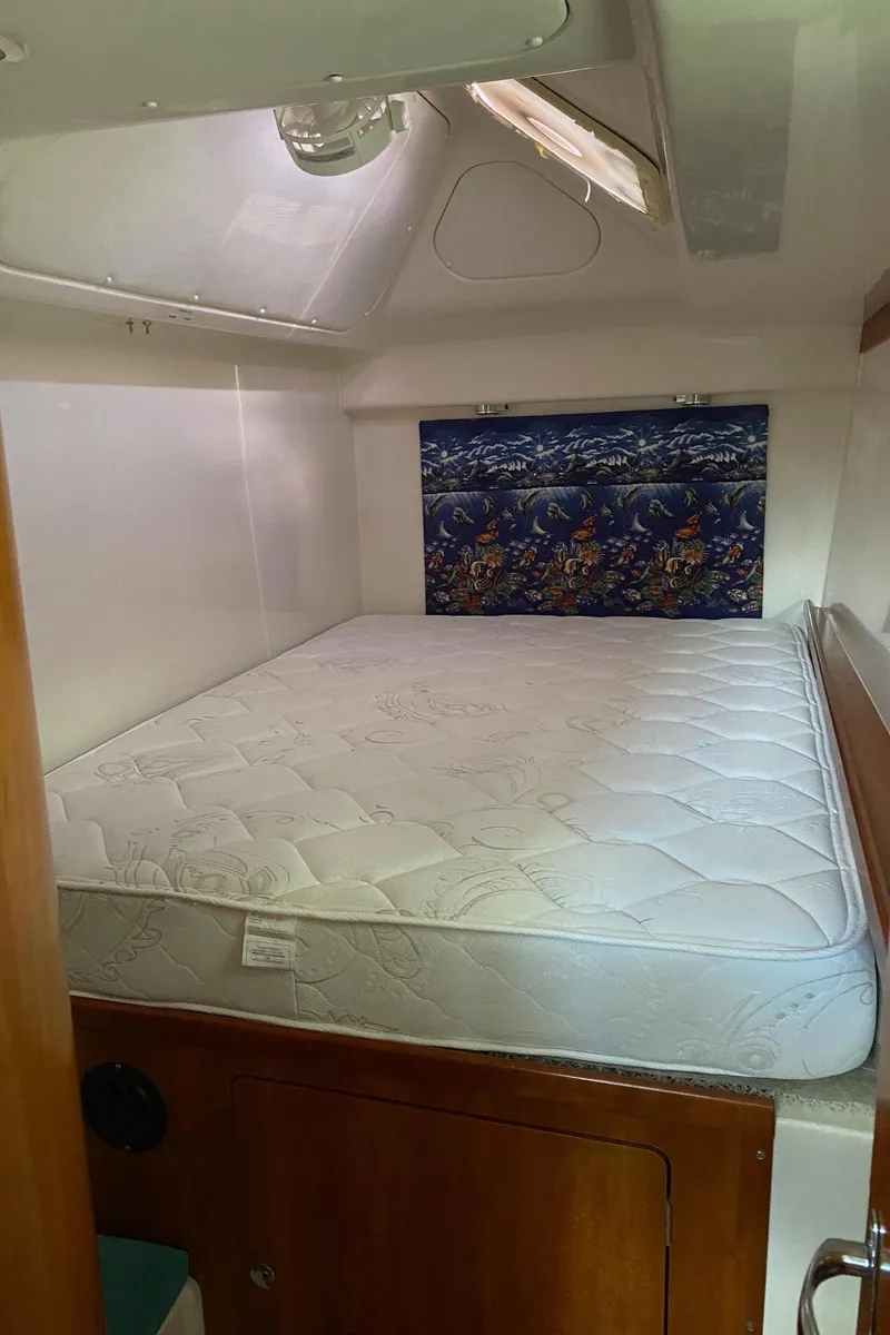 Slide: The Image of Cozy cabin interior of 2008 PDQ MV-41 with blue bedding and decorative pillow. - 43