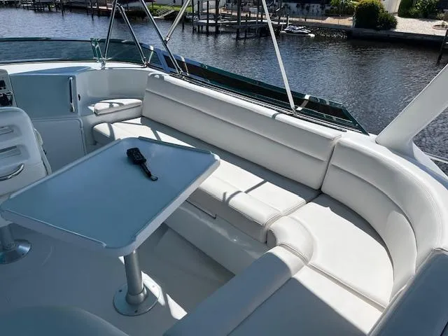 Slide: The Image of Helm of 2008 PDQ MV-41 boat with steering wheel and navigation equipment, overlooking a serene waterway. - 48