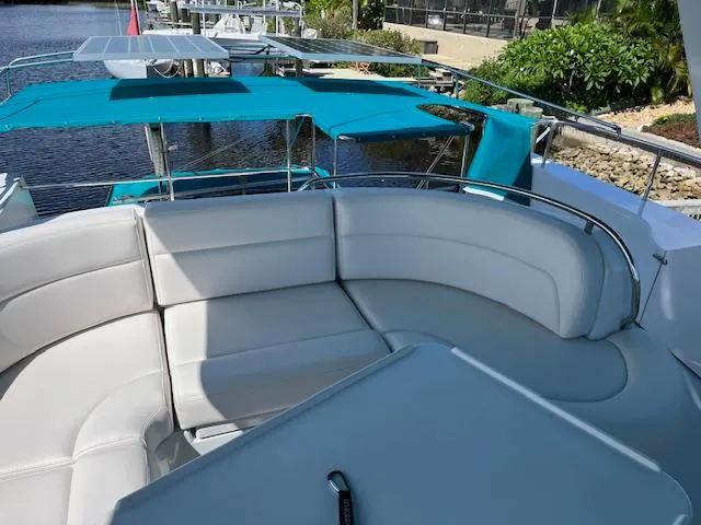 Slide: The Image of Luxurious seating area on a 2008 PDQ MV-41 boat, featuring a table and waterfront view. - 50