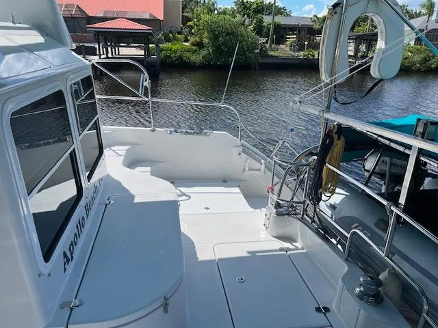 Slide: The Image of Turquoise canopy on PDQ MV-41 boat, 2008 model, with scenic waterfront view. - 58