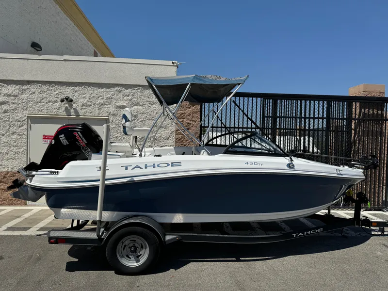 Slide: The Image of 2021 Tracker Tahoe 450 TF boat on trailer, parked outdoors. - 1