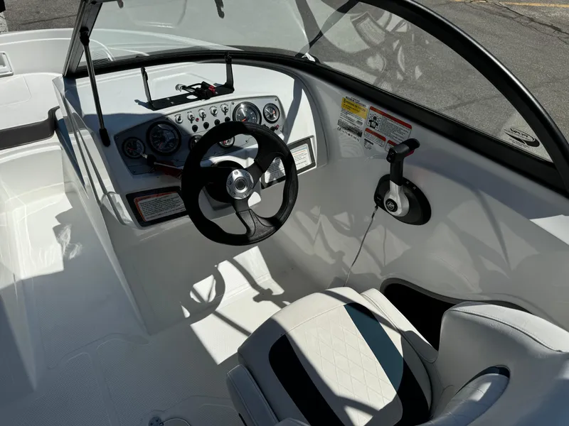 Slide: The Image of 2021 Tracker Tahoe 450 TF boat cockpit with steering wheel and control panel. - 11