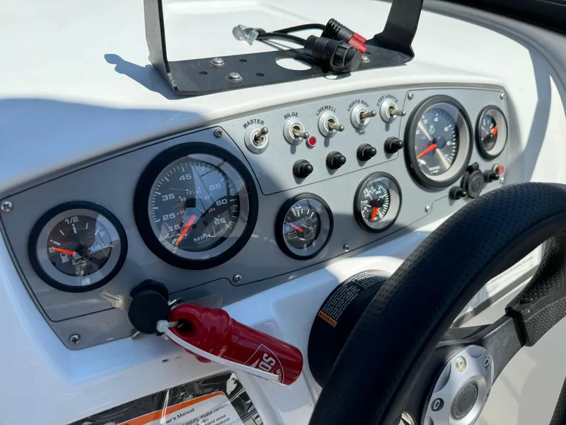 Slide: The Image of Dashboard of a 2021 Tracker Tahoe 450 TF boat with gauges and controls. - 12