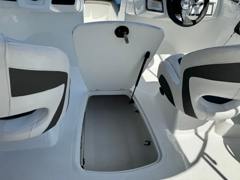 Slide: The Image of 2021 Tracker Tahoe 450 TF boat interior with open storage compartment. - 14