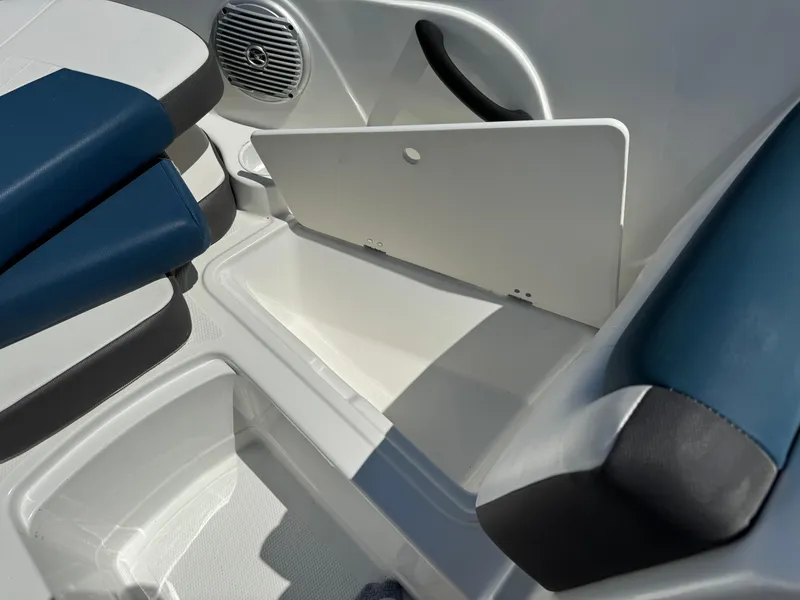 Slide: The Image of 2021 Tracker Tahoe 450 TF boat interior storage compartment with blue and white seating. - 15