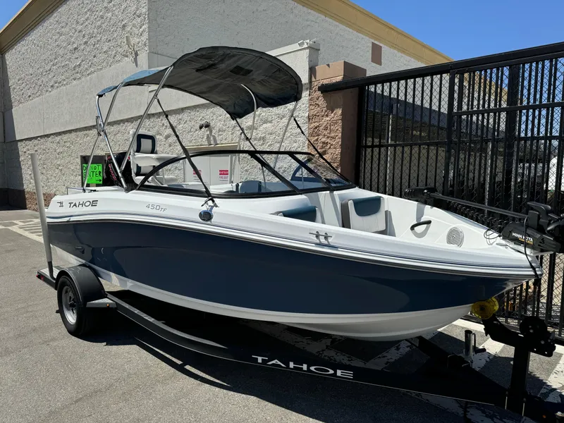 Slide: The Image of 2021 Tracker Tahoe 450 TF boat on trailer, parked outdoors. - 2
