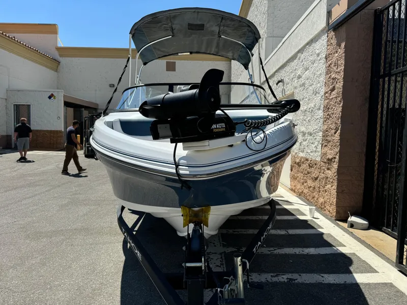 Slide: The Image of 2021 Tracker Tahoe 450 TF boat on trailer in outdoor setting. - 4