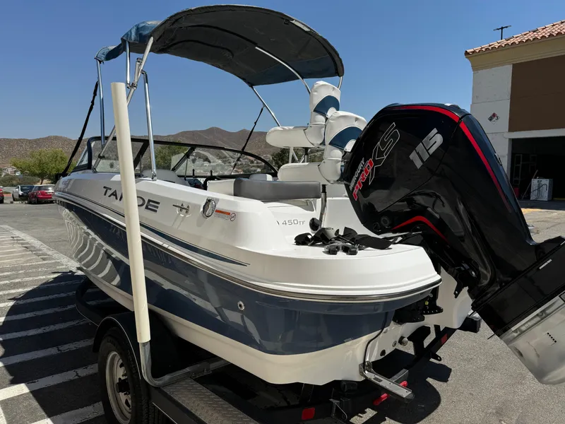 Slide: The Image of 2021 Tracker Tahoe 450 TF boat with 115 HP engine on trailer. - 6