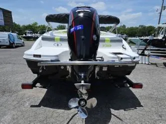 Slide: The Image of 2022 Tahoe T18 boat with outboard motor, rear view in a marina. - 3