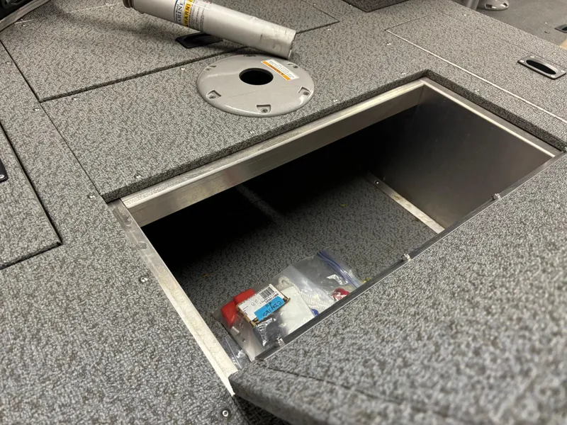 Slide: The Image of 2021 Crestliner 1650 Discovery SC boat storage compartment with accessories. - 2