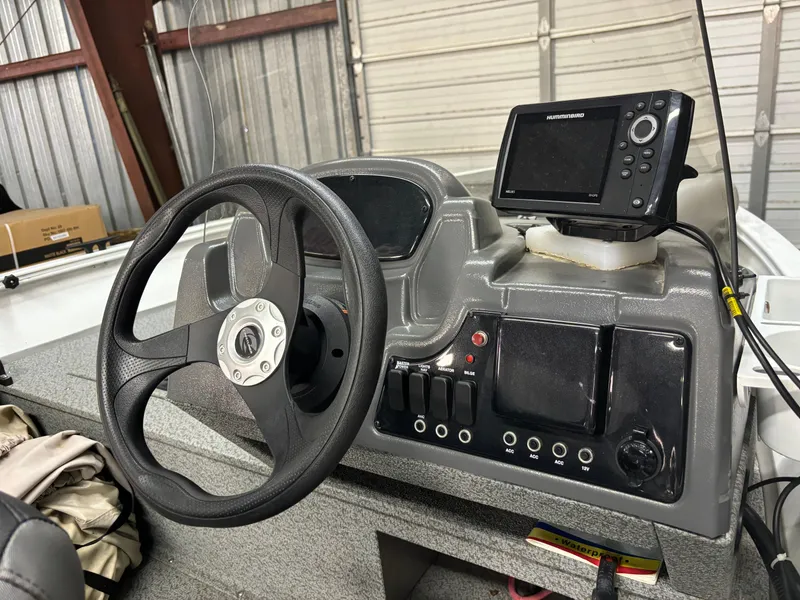 Slide: The Image of 2021 Crestliner 1650 Discovery SC dashboard with steering wheel and fishfinder. - 5