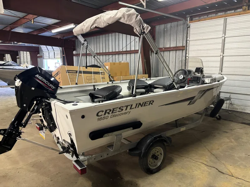 Slide: The Image of 2021 Crestliner 1650 Discovery SC boat in a storage facility. - 7