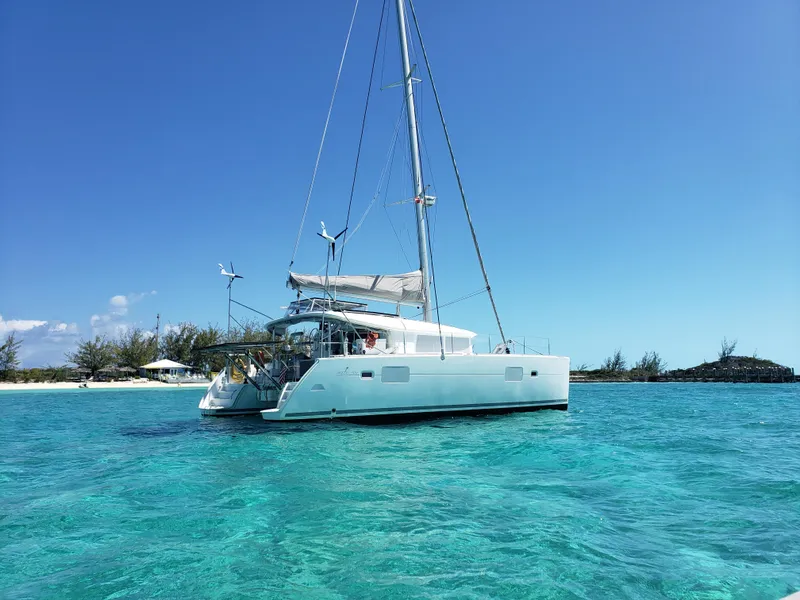 Slide: The Image of 2010 Lagoon 400 owner's version catamaran sailing in clear turquoise waters. - 1