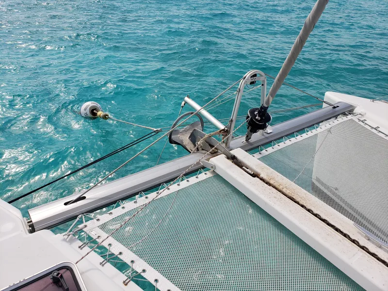 Slide: The Image of Lagoon 400 catamaran bow with netting, 2010 model, on clear turquoise water. - 17