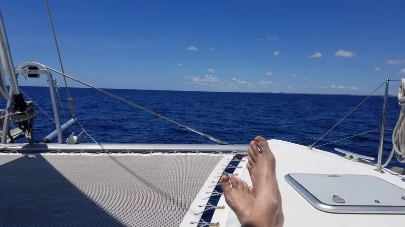 Slide: The Image of Relaxing on a 2010 Lagoon 400 catamaran, enjoying the open sea and clear blue sky. - 18
