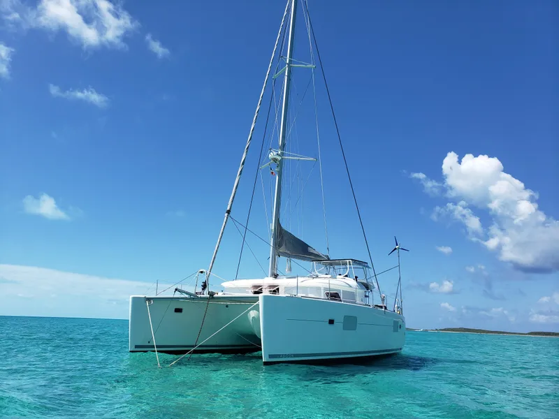 Slide: The Image of Lagoon 400 catamaran sailing in clear turquoise waters under a bright blue sky. - 2