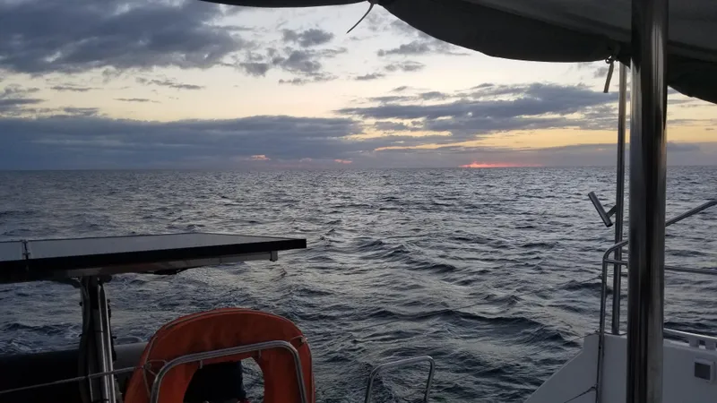 Slide: The Image of Sunset view from Lagoon 400 sailboat, 2010 model, on open sea. - 22