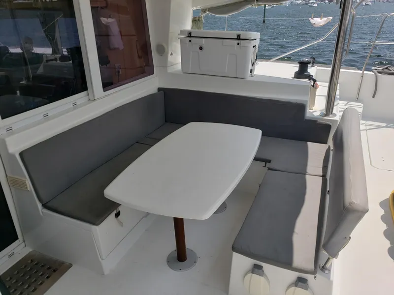 Slide: The Image of Lagoon 400 owner's version 2010 yacht with outdoor seating and table on deck. - 27