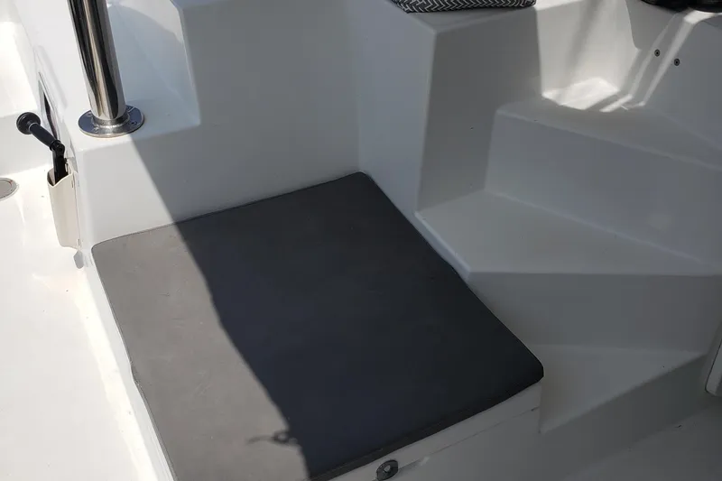 Slide: The Image of Cushioned seating area on 2010 Lagoon 400 owner's version catamaran deck. - 29