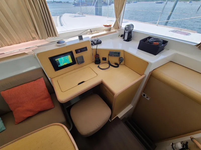 Slide: The Image of Navigation station on 2010 Lagoon 400 owner's version catamaran with electronics and seating. - 30