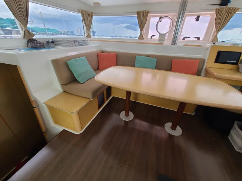 Slide: The Image of Interior of 2010 Lagoon 400 owner's version catamaran with dining area and colorful cushions. - 32