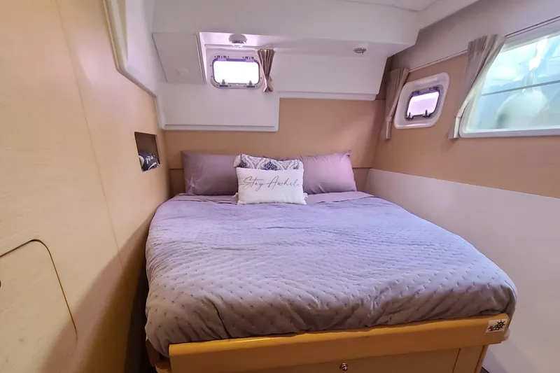 Slide: The Image of Cozy bedroom in 2010 Lagoon 400 owner's version catamaran with soft bedding and natural light. - 36