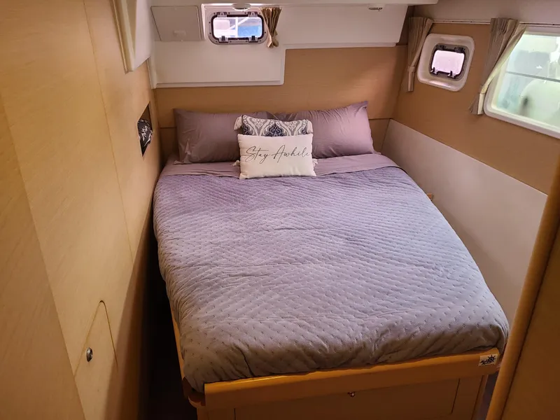 Slide: The Image of Cozy bedroom in 2010 Lagoon 400 owner's version catamaran with plush bedding and natural light. - 37
