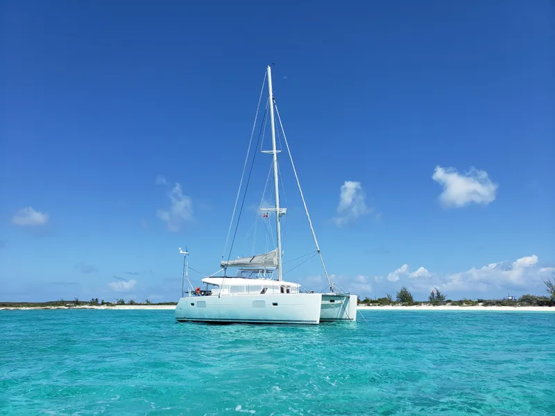 Slide: The Image of 2010 Lagoon 400 catamaran sailing in clear turquoise waters under a bright blue sky. - 4
