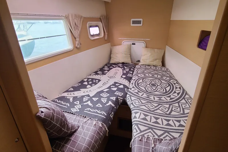 Slide: The Image of Cozy cabin interior of 2010 Lagoon 400 owner's version with twin beds and patterned bedding. - 40